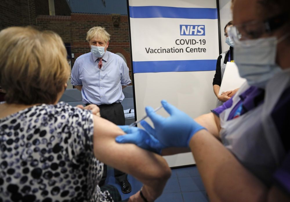 London: British Prime Minister Boris Johnson watches as nurse Rebecca Cathersides administers the Pfizer-BioNTech COVID-19 vaccine to Lyn Wheeler at Guy's Hospital in London, Tuesday, Dec. 8, 2020. U.K. health authorities rolled out the first doses of a widely tested and independently reviewed COVID-19 vaccine Tuesday, starting a global immunization program that is expected to gain momentum as more serums win approval. AP/PTI